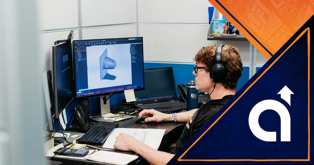 Engineer at American Crane working at his desk on a custom crane design project