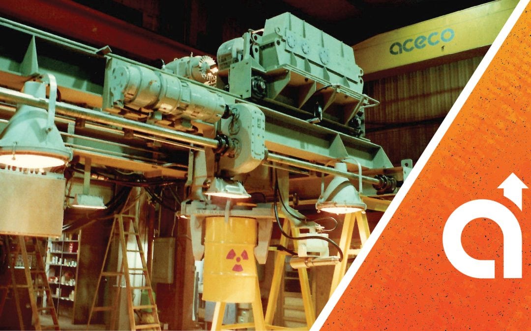 "Industrial machinery and pipework in a warehouse, overlaid with an orange graphic and the ACECO logo